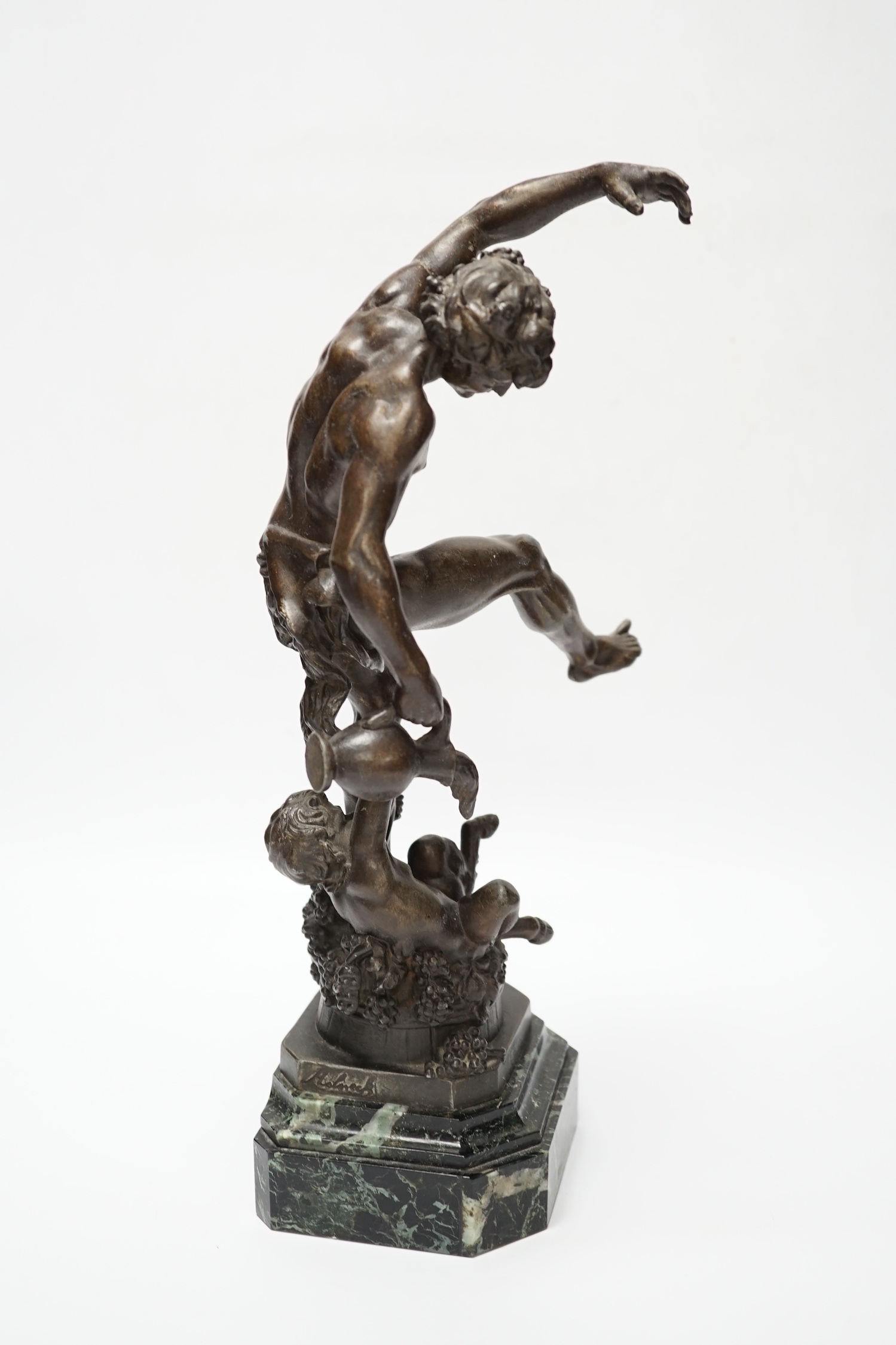 A bronzed spelter dancing figure of Bacchus - ‘Le Vin’, with a fawn and bunches of grapes, on a marble base, 36cm high